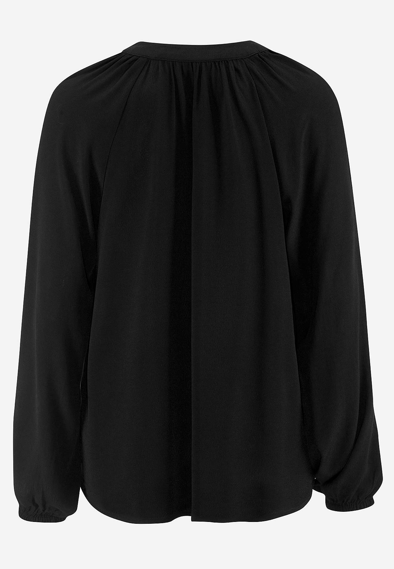 Blus med volanger